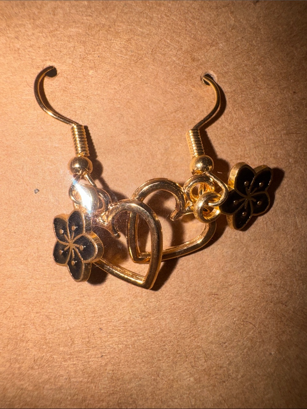 Gold Heart Dangle Earrings with Black Flower Accents
